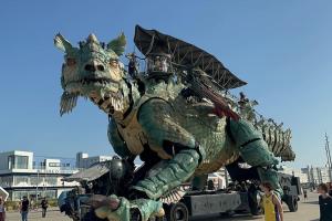 a large dragon statue on a parade float at Le Street in Calais