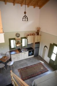 a kitchen with a table and a stove top oven at La Familia Luxury Private Maisonettes near the sea in Gythio