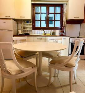 a kitchen with a table and chairs in a kitchen at NUX Luxury Apartments in Alexandroupoli