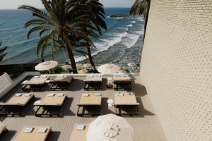 a view of the beach from a hotel with tables and umbrellas at Don Gregory by Dunas - Adults Only in San Agustin
