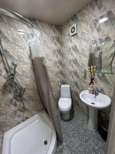 a bathroom with a toilet and a sink at MR Guest House in Tbilisi City