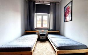 Posteľ alebo postele v izbe v ubytovaní Apartament Peowiaków Superior