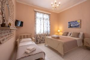 a bedroom with two beds and a window at Patriko Retro House in Fourka