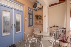 a small balcony with a table and chairs at Patriko Retro House in Fourka