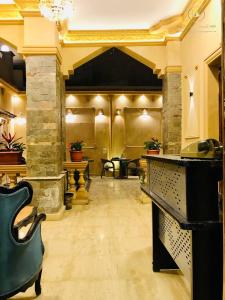 a lobby with a bar with chairs and a fireplace at Sidi Hamad Pyramids INN in Cairo