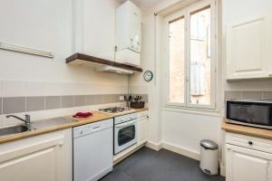 a kitchen with white appliances and a window at Impasse ste martianne in Albi