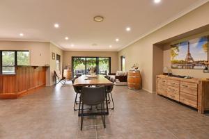 a large living room with a table and a couch at The Residence - Ironstone Estate Hunter Valley in Lovedale