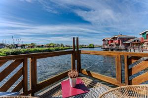 a balcony with a view of the water and houses at Maison Ostrea - Gujan in Gujan-Mestras