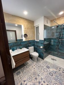 a bathroom with a toilet and a sink and a shower at My Travel House in Rabat +128 photos
