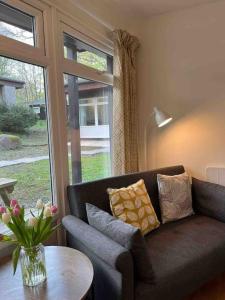 a living room with a couch and a table and a window at Stepping Stones Cottage - Lelant, Nr St Ives in St Ives +17 photos