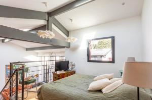 a bedroom with a bed and a loft at Cosy loft in Courbevoie in Courbevoie