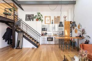 a kitchen with a spiral staircase and a table at Cosy loft in Courbevoie in Courbevoie