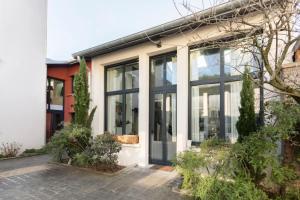 a house with large glass doors on it at Cosy loft in Courbevoie in Courbevoie