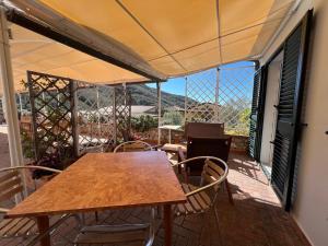 a table and chairs on a balcony with a view at Agriturismo Paradisa in Rio nellʼElba