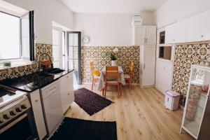 a kitchen with a table and a dining room at Casa das Pomegranates in Ílhavo