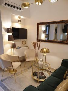 a living room with a couch and a table and a mirror at Split Old Town Oasis in Split