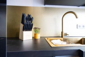 a kitchen counter with a knife block next to a sink at Stilvolle Stadtwohnung in Duisburg +17 photos