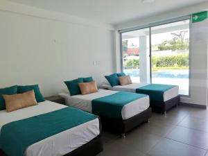 מיטה או מיטות בחדר ב-Finca Hotel Santa Catalina