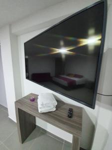 uma grande televisão de ecrã plano pendurada numa parede em Finca Hotel Santa Catalina em La Rochela