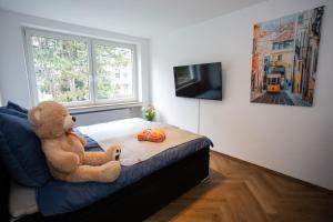 a teddy bear sitting on a bed in a bedroom at Stilvolle Stadtwohnung in Duisburg