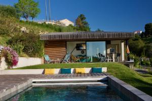 a house with a swimming pool in front of a house at La Coulina in Nice