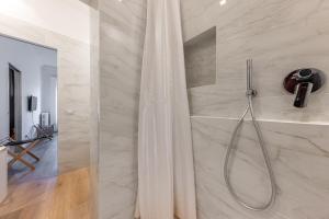 un bagno con doccia con tenda da doccia di Sant'Andrea Charme Apartments a Milano Altre 49 foto