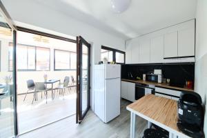 a kitchen with a white refrigerator and a table at Old Town Retreat Studio 9 in Bucharest