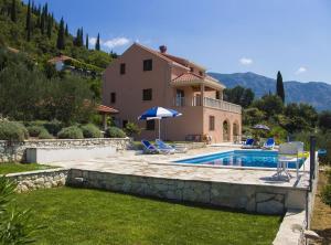 a villa with a swimming pool and a house at Villa Oliva in Gruda