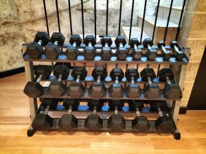 a row of dumbbells in a gym at Hotel Peyris Opera in Paris