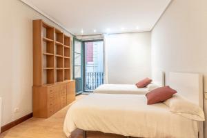 מיטה או מיטות בחדר ב-Apartamento Uribitarte