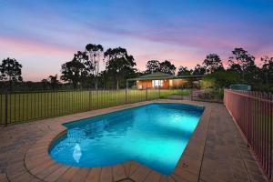 a swimming pool in a yard with a fence at 5br Bbq Hot Tub Family Farm Stay Homestead in Lovedale