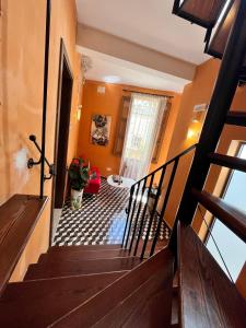 a staircase in a home with orange walls at My Travel House in Rabat