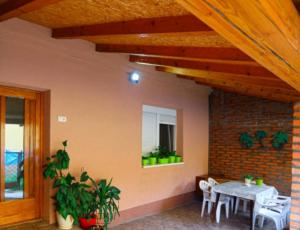 a patio with a table and chairs and a window at Apartman Biljana in Šabac
