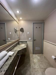 a bathroom with a sink and a mirror at Getaflat-1504 Berrini 4 estrelas in São Paulo