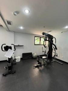 a room with a gym with a treadmill and weights at Getaflat-1504 Berrini 4 estrelas in São Paulo