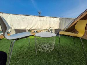 two chairs and a table on the grass in a tent at Jin House Incheon Geomamstation in Incheon