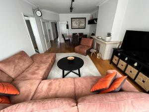 a living room with a couch and a table at Spacious 2 Bedroom App in the Center with Balcony in Ghent