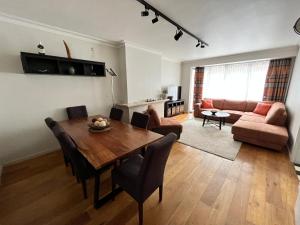a living room with a wooden table and a couch at Spacious 2 Bedroom App in the Center with Balcony in Ghent