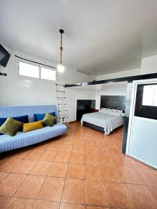 a bedroom with a couch and a bed and a ladder at Belyounech studio location de vacance in Tétouan