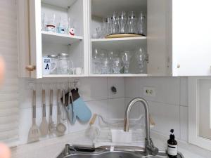 a kitchen with a sink and utensils in cabinets at Jin House Incheon Geomamstation in Incheon +88 photos