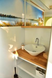 a bathroom with a sink and a window at Hausboot Hafen am Speicher in Lübz