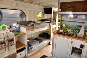 an rv with two bunk beds and a kitchen at Hausboot Hafen am Speicher in Lübz
