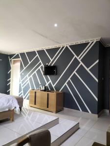 a bedroom with a bed and a wall mural at Mpatsa Quest Hotels in Lilongwe