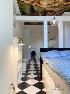 a bedroom with a bed and a checkered floor at 5Seasons Apartments Krakow Center in Krakow