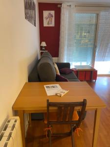 a living room with a table and a couch at Appartement tranquille Sitges 5km in Sant Pere de Ribes