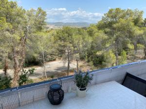 a balcony with two vases sitting on a table at Appartement tranquille Sitges 5km in Sant Pere de Ribes
