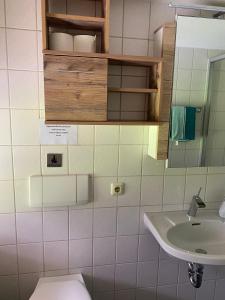 a bathroom with a sink and a toilet and a mirror at Hansenbauernhof in Ruhpolding