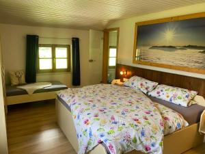 a bedroom with a bed and a large painting on the wall at Hansenbauernhof in Ruhpolding