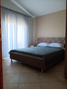 a bedroom with a bed and a window at Babis House in Limenaria