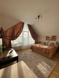 a bedroom with two beds and a large window at S'Vitt in Skhidnitsa